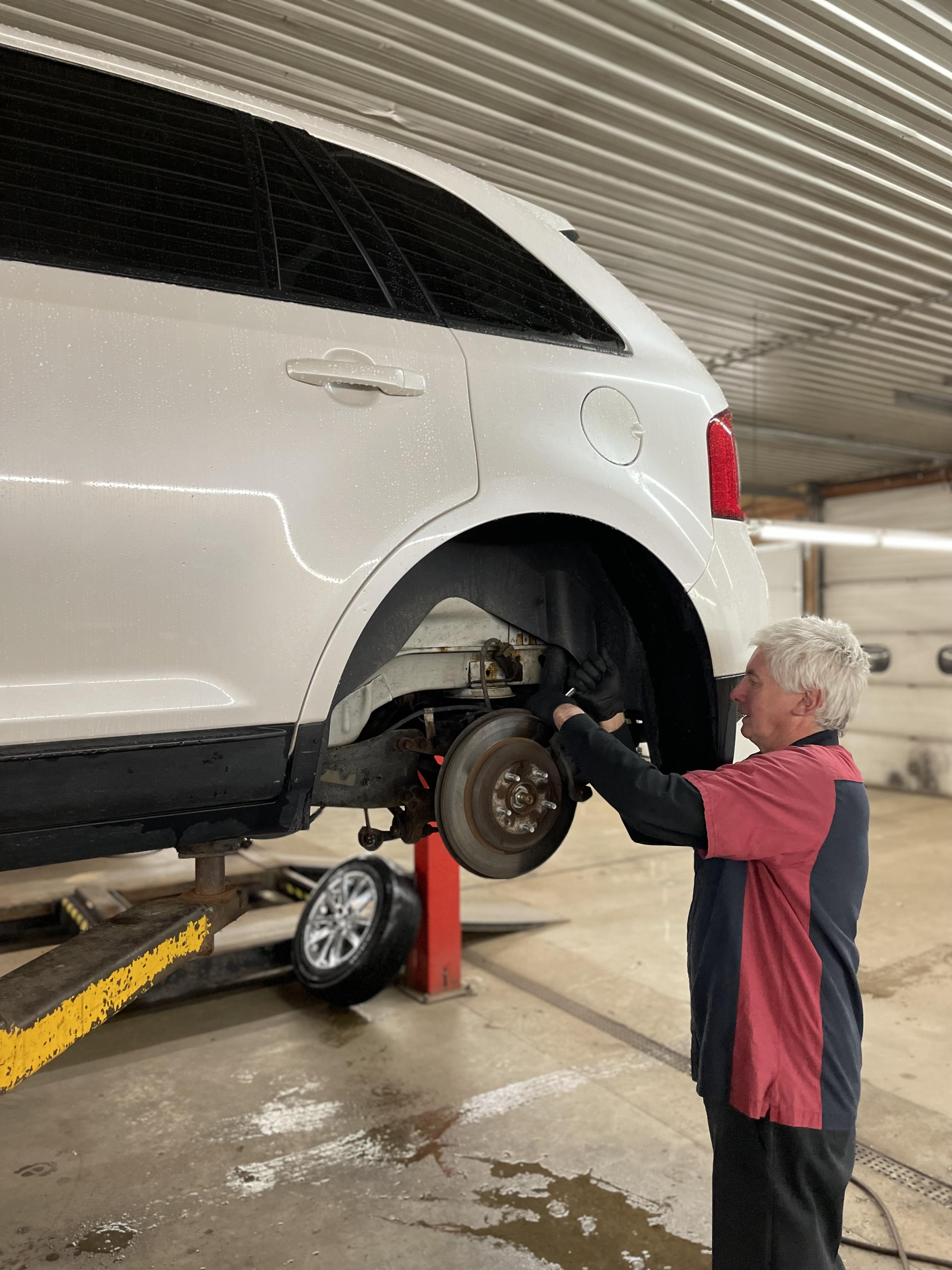 A mechanic working on a brake job