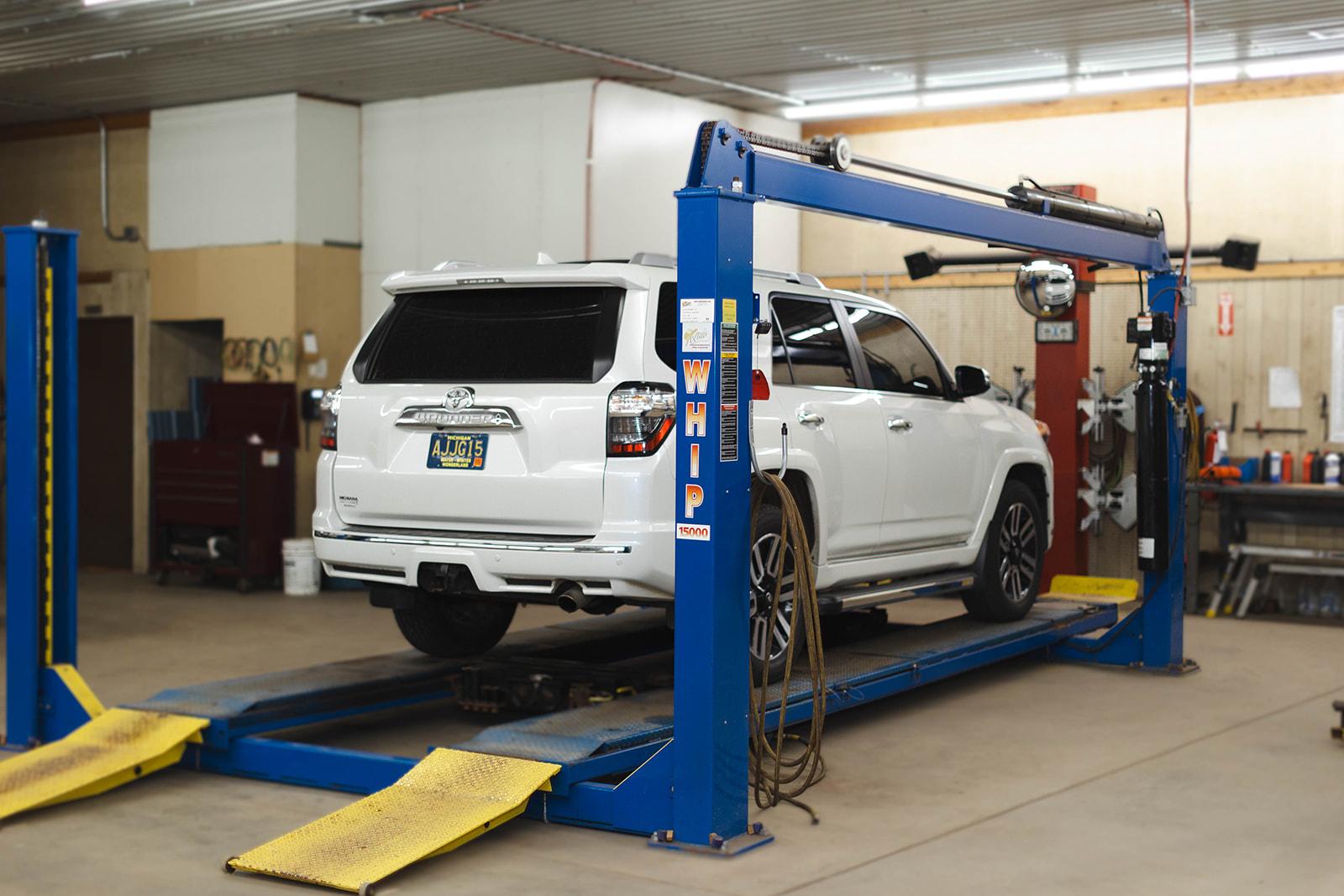 A vehicle raised on the alignment lift