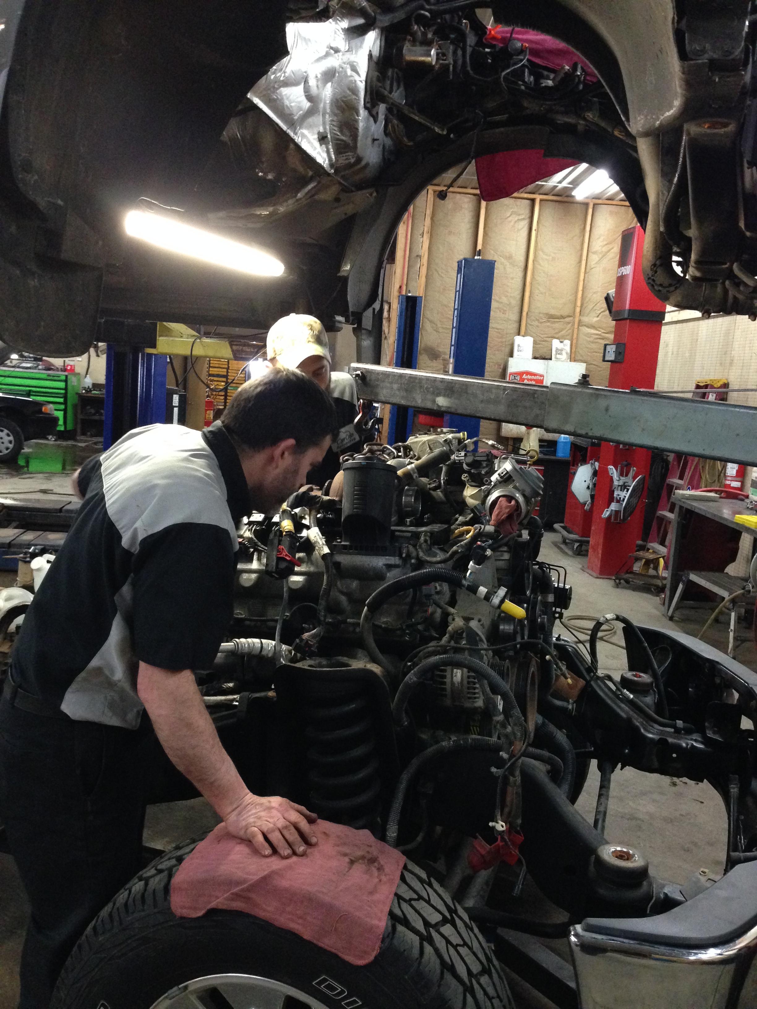Carr Craft mechanics working on an engine