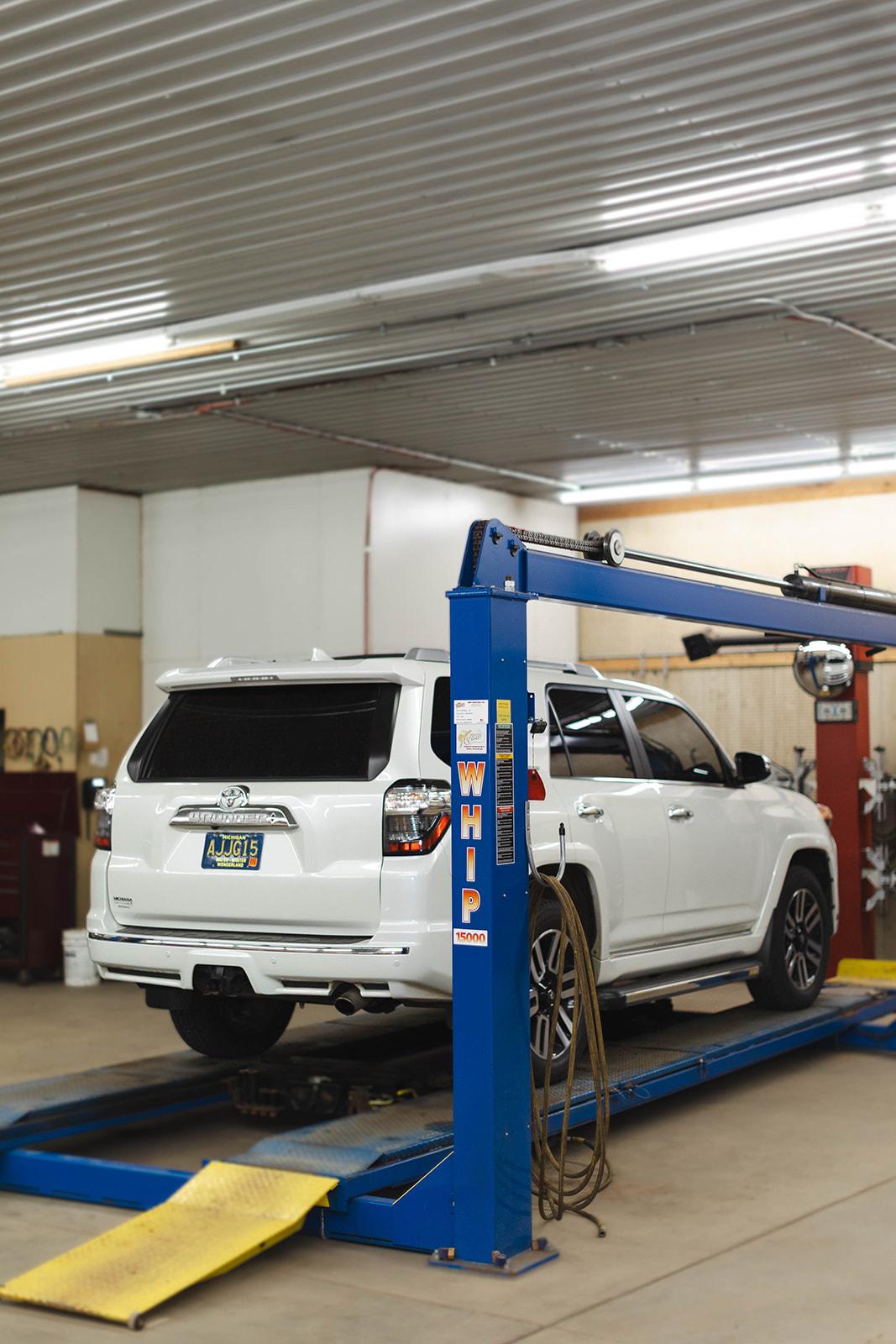 A vehicle up on the lift at Carr Craft Automotive